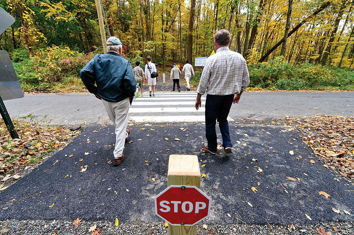 Supporters of the Norwalk River Valley Trail (NRVT) hike a half-mile from Route 7 to attend the official announcement of the opening of a new section of the east-side "Wilton Loop" Saturday.