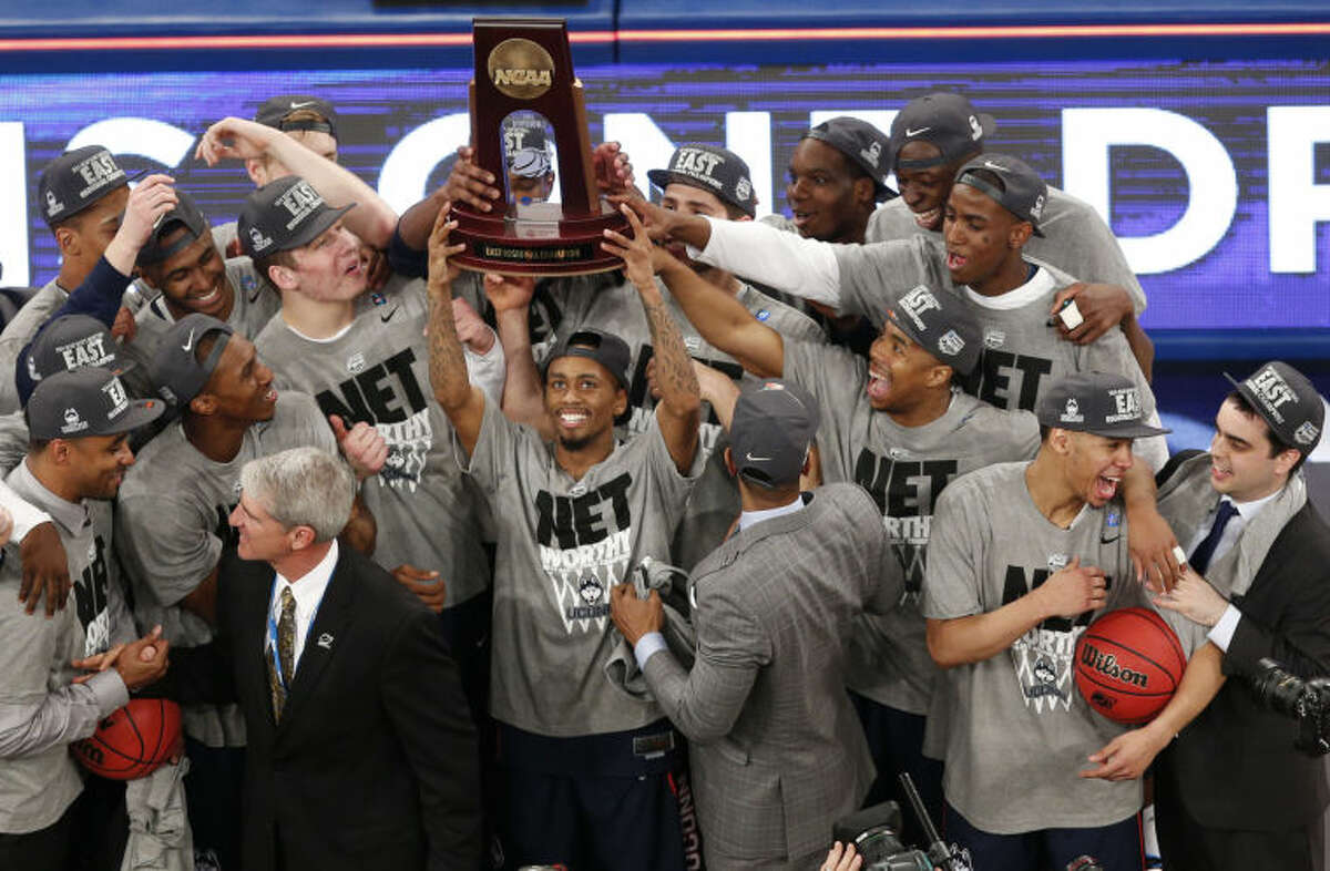 Connecticut players celebrate after defeating Michigan State during a regional final at the NCAA college basketball tournament, Sunday, March 30, 2014, in New York. (AP Photo/Julio Cortez)