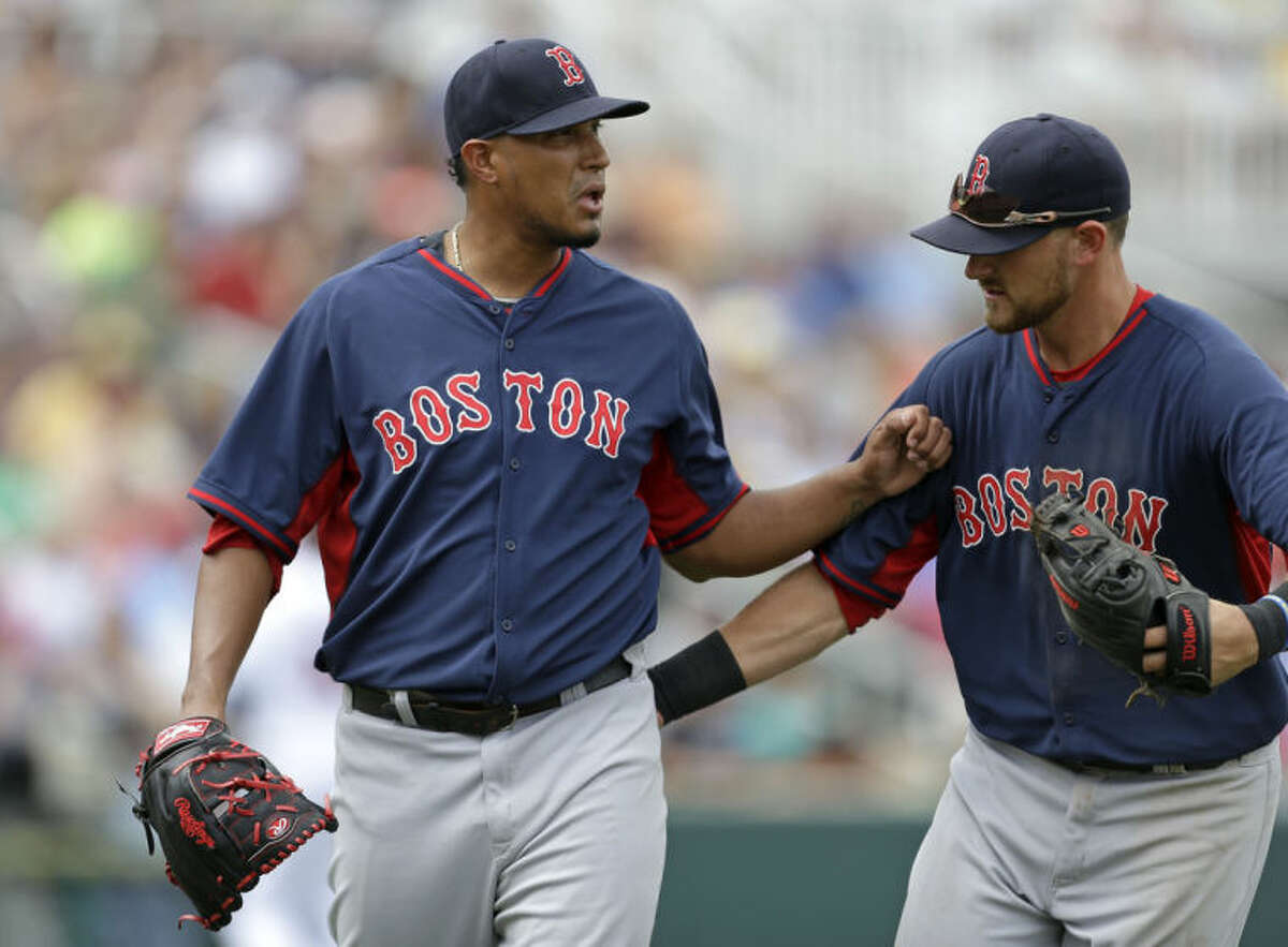 Boston Red Sox third baseman Will Middlebrooks, right, pats starting pitcher Felix Doubront (22) as he walks off the mound at the end of the fourth inning of an exhibition baseball game against the Minnesota Twins in Fort Myers, Fla., Friday, March 28, 2014. (AP Photo/Gerald Herbert)