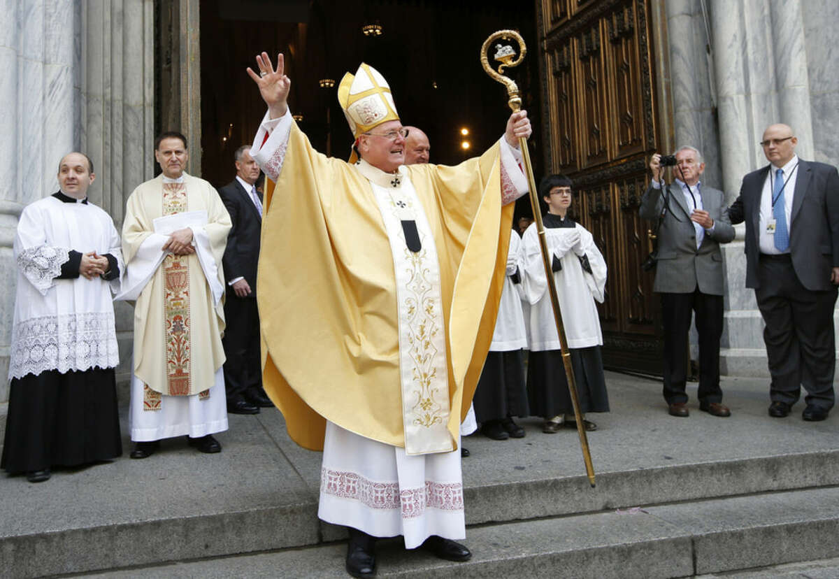 Cardinal Timothy Dolan blesses the crowd from the steps of St. Patrick's Cathedral in Manhattan after leading Easter Mass inside the landmark church, Sunday, March 27, 2016, in New York. (AP Photo/Kathy Willens)