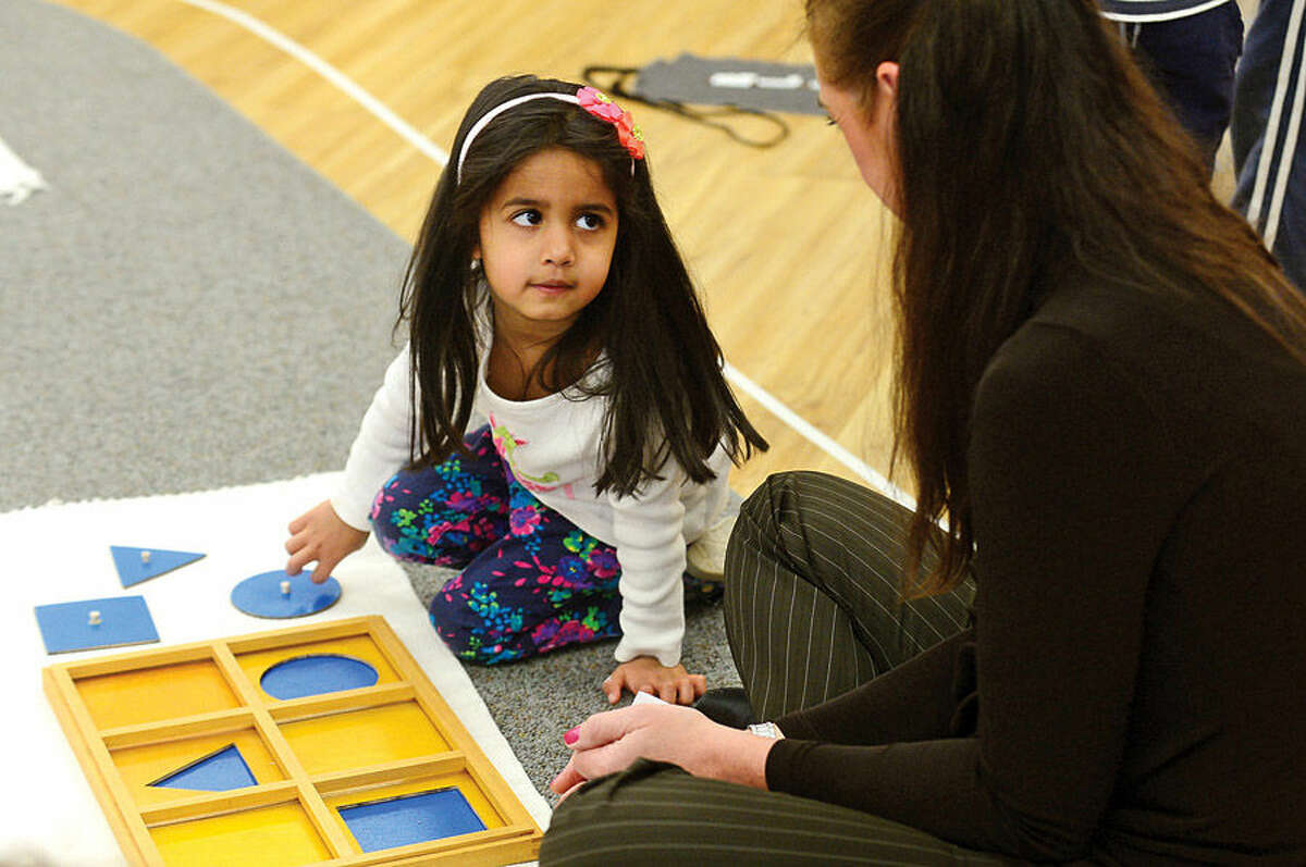 Hour photo / Erik Trautmann Students at the Montessori School in Wilton engage in educational activity during their time at the school Wednesday. Montessori education is an approach characterized by an emphasis on independence, freedom within limits, and respect for a child’s natural psychological, physical, and social development.