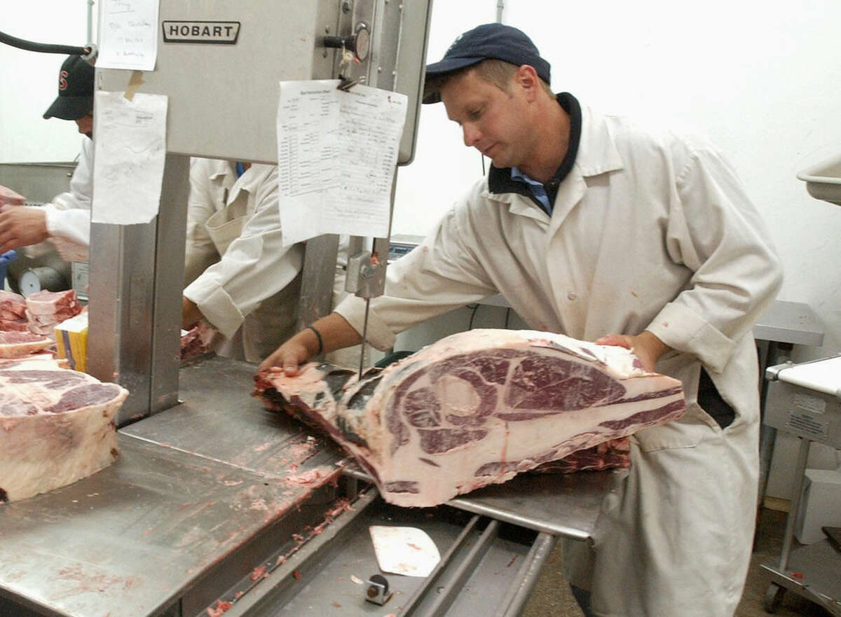 In a June 22, 2005 photo, Scott Bittner, owner of Bittner's Eureka Locker, processes beef at his business in Eureka, Ill. On Tuesday, April 7, 2015, the Chicago Tribune quoted Scott Barrows as saying his daughter's husband Scott Bittner, 42, of Towanda, Ill., was among the seven people killed when the small plane they were in crashed in a central Illinois field near Bloomington early Tuesday, April 7, 2015. The Cessna 414 twin-engine aircraft took off from Indianapolis and crashed just short of the Central Illinois Regional Airport in Bloomington after midnight, the Federal Aviation Administration said. The plane was returning from the NCAA Final Four tournament. (AP Photo/The Pantagraph, Carlos T. Miranda)