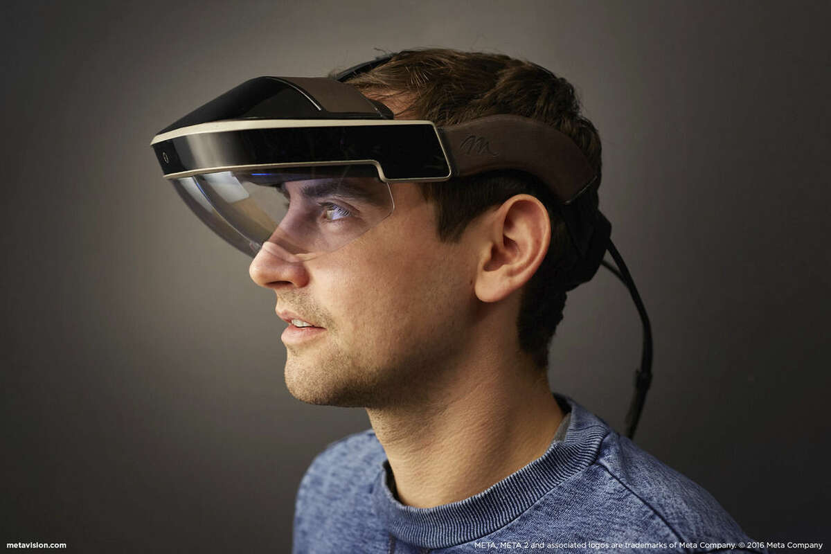Stephen Schauer/Meta via AP In this February 2016 photo provided by Meta, Meta employee Martin Hasek wears a Meta 2 headset, in Redwood City, Calif. While startups like Meta, Magic Leap and Atheer have been making the most visible progress in augmented reality so far, technology heavyweights are also eyeing it.