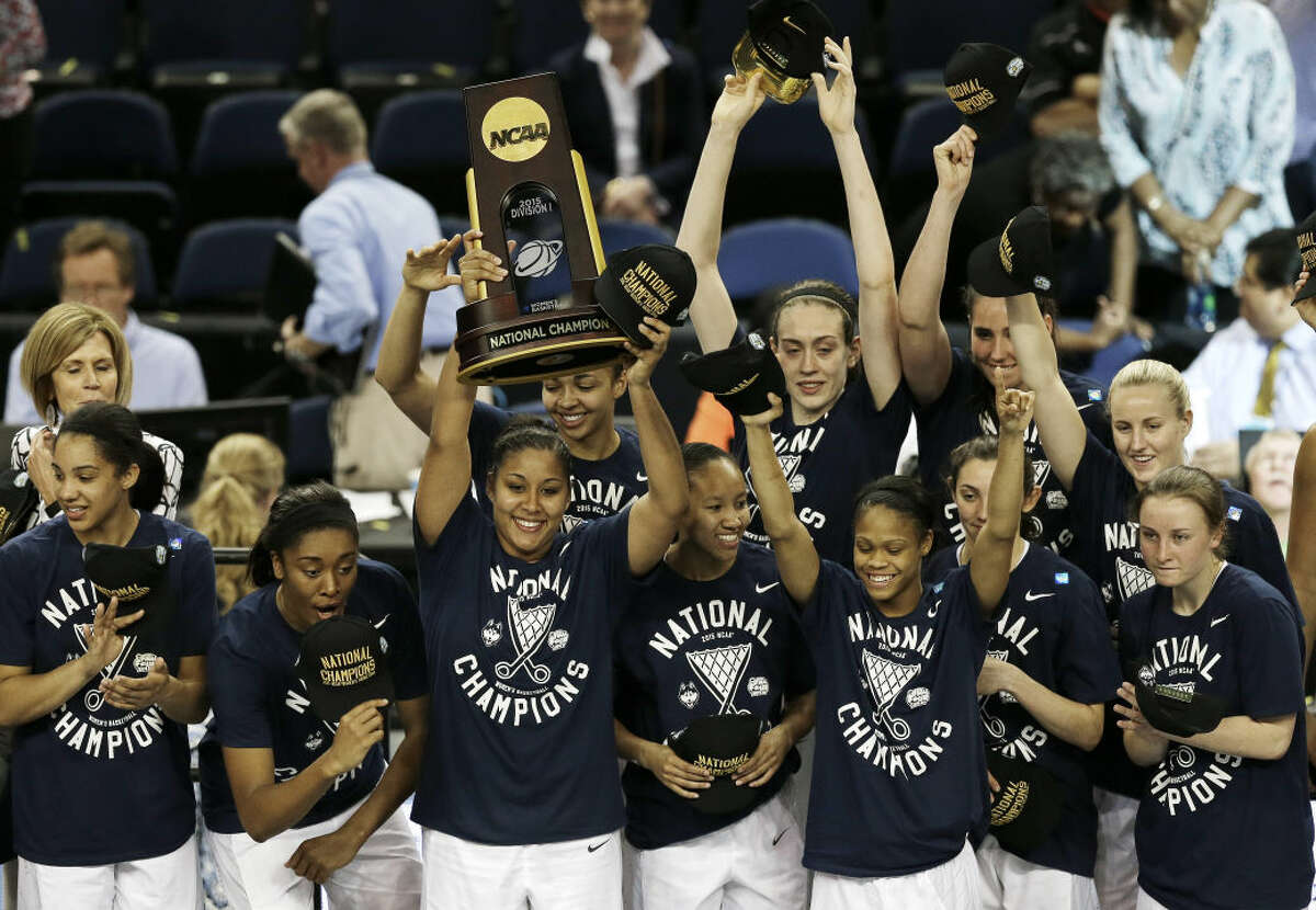 Connecticutplayers pose with the national championship trophy after the NCAA women's Final Four tournament college basketball championship game against Notre Dame, Tuesday, April 7, 2015, in Tampa, Fla. Connecticut won 63-53. (AP Photo/Chris O'Meara)