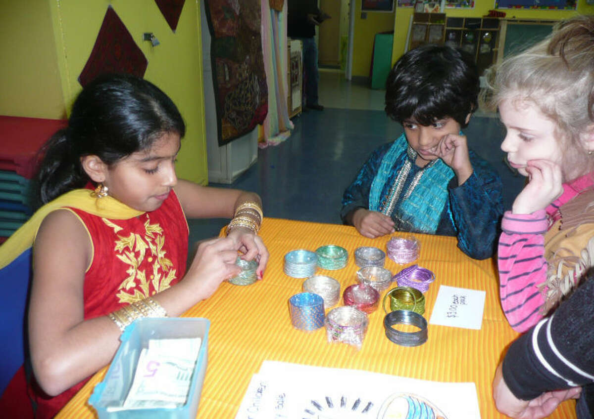 Young attendees are pictured admiring colorful bracelets offered at a booth during the previous Indian Festival hosted by the Wilton Family Y.