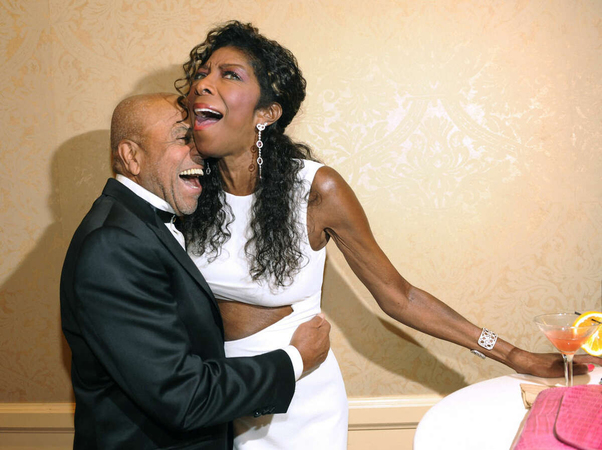 FILE - In a Saturday, Oct. 11, 2014 file photo, Motown Records founder Berry Gordy, left, embraces singer Natalie Cole at the 2014 Carousel of Hope Ball at the Beverly Hilton Hotel, in Beverly Hills, Calif. Cole, the daughter of jazz legend Nat "King" Cole who carried on his musical legacy, died Thursday night, Dec. 31, 2015, according to publicist Maureen O'Connor. She was 65. (Photo by Chris Pizzello/Invision/AP, File)