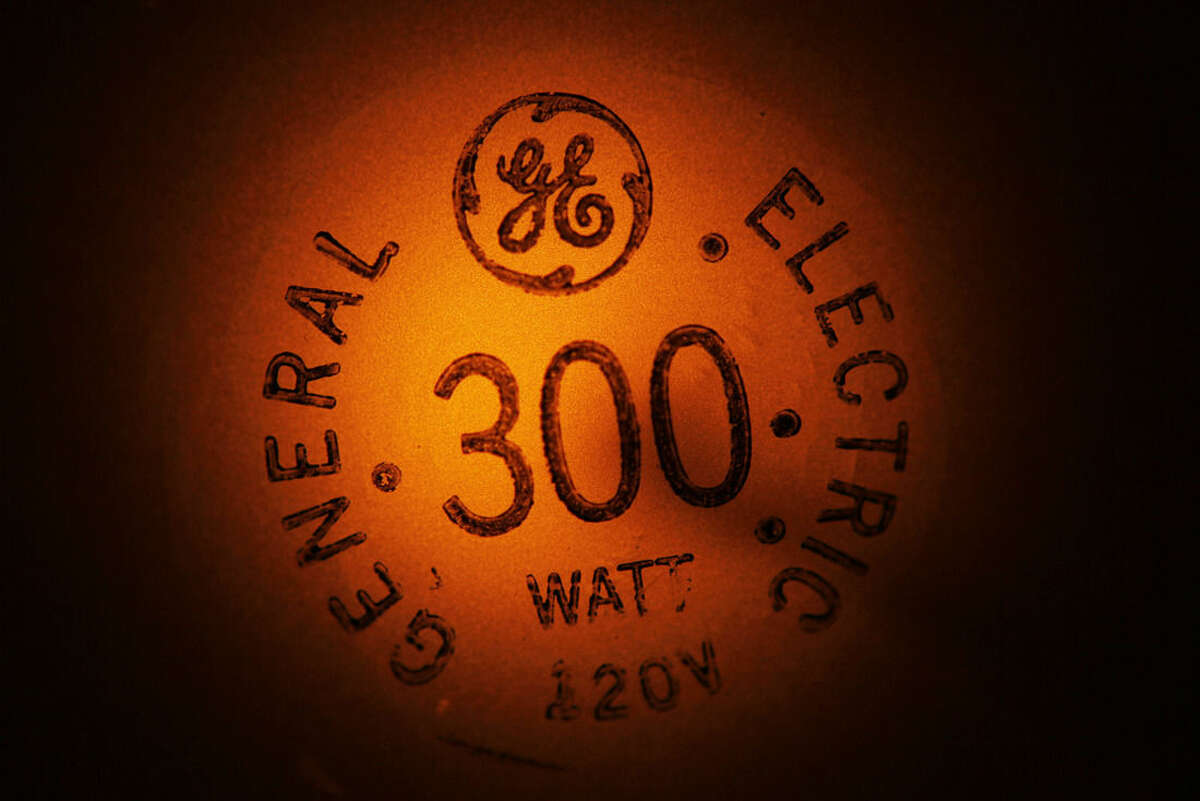 In this photo taken Jan. 14, 2011, a General Electric light bulb glows as it is turned off in Buffalo, N.Y. General Electric Co. (GE) on Friday April 17, 2015 reported a first-quarter loss of $13.57 billion, after reporting a profit in the same period a year earlier. (AP Photo/David Duprey, File)