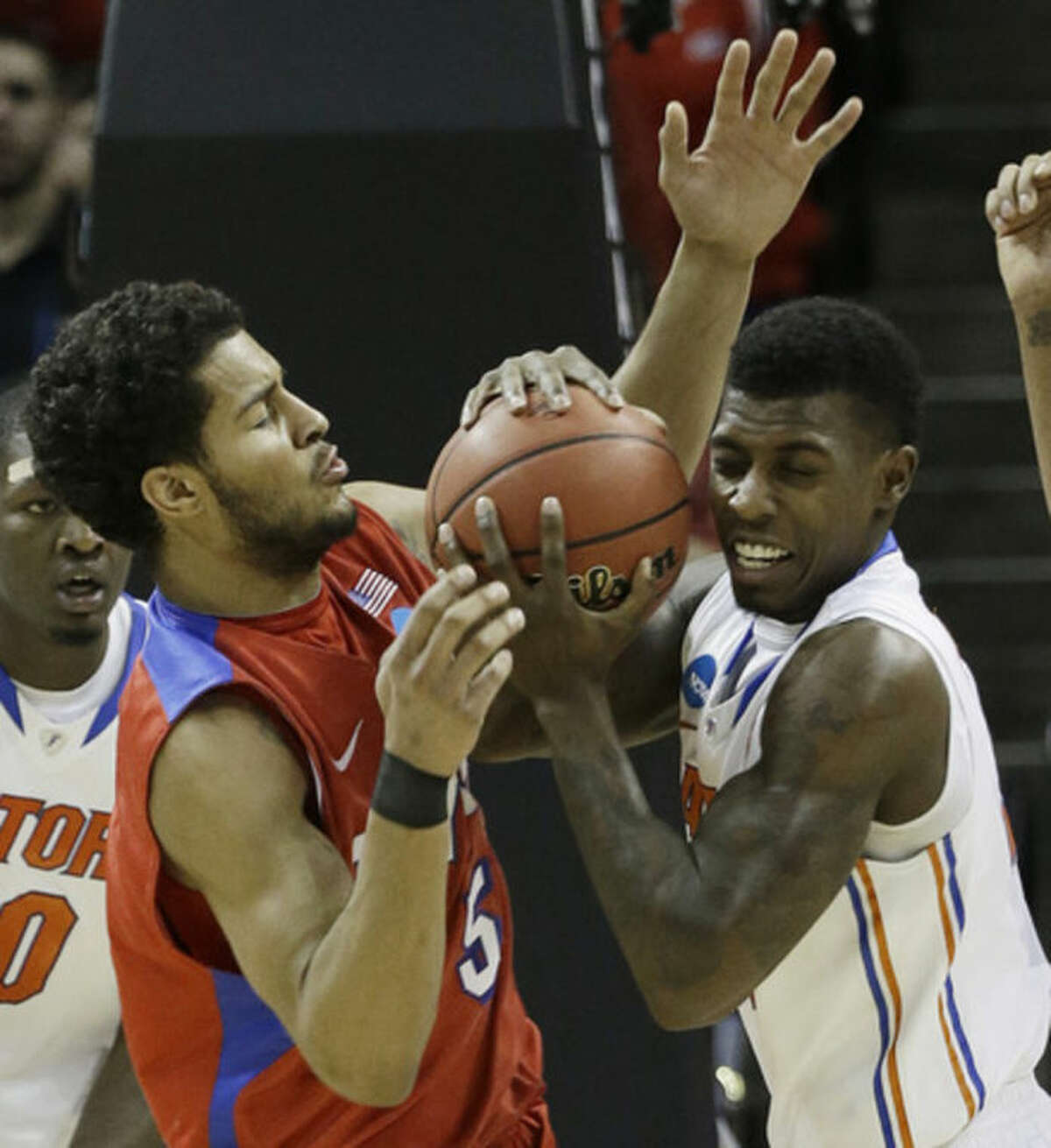 Florida forward Casey Prather (24) holds the ball as Dayton forward Devin Oliver (5) defends during the second half in a regional final game at the NCAA college basketball tournament, Saturday, March 29, 2014, in Memphis, Tenn. (AP Photo/Mark Humphrey)