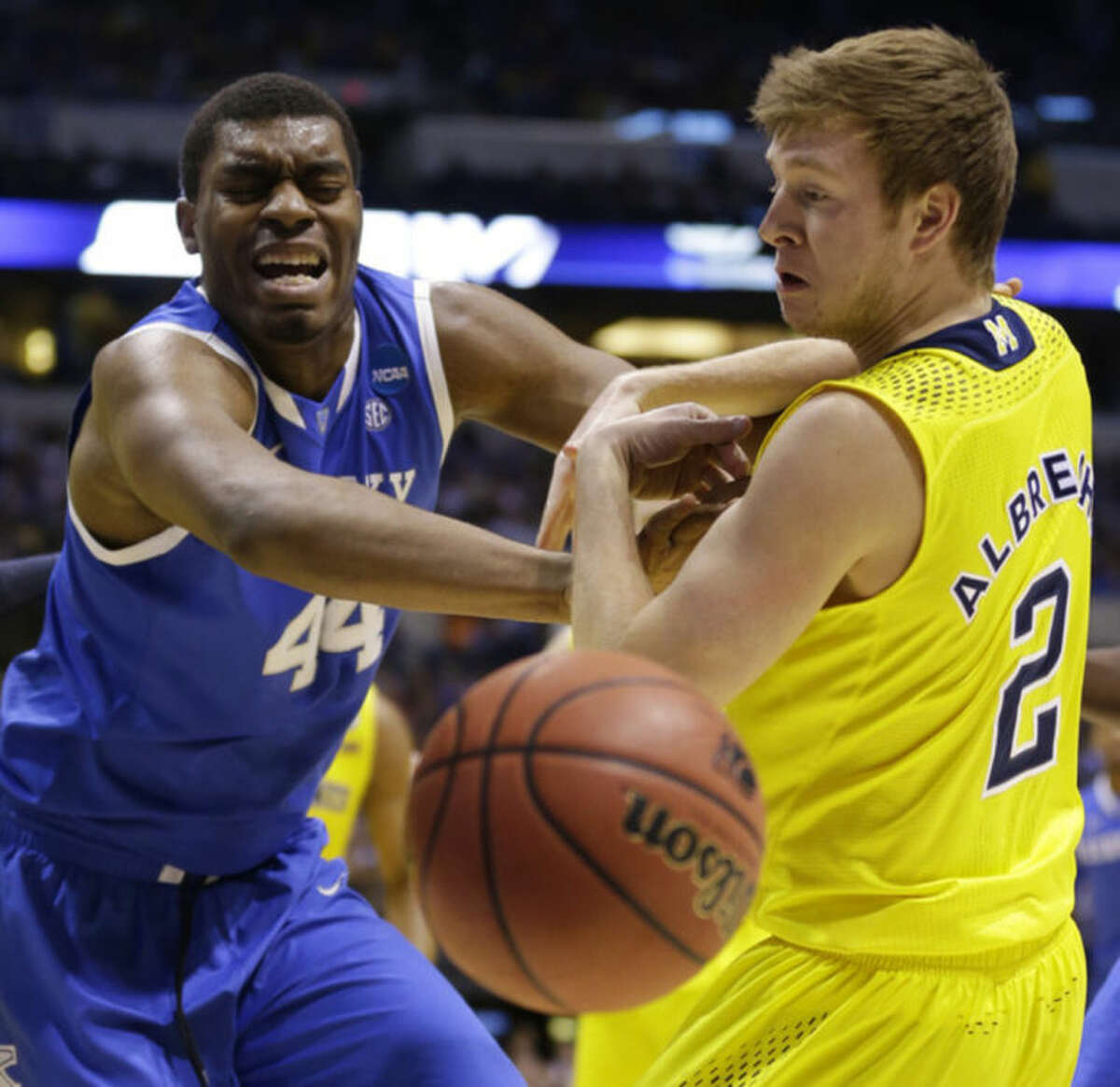 Kentucky's Dakari Johnson (44) and Michigan's Spike Albrecht (2) go after a loose ball during the first half of an NCAA Midwest Regional final college basketball tournament game Sunday, March 30, 2014, in Indianapolis. (AP Photo/Michael Conroy)