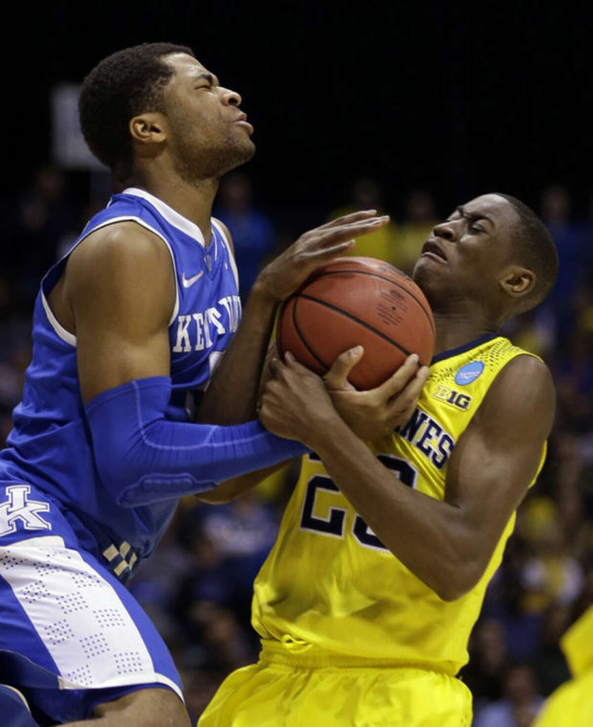 Kentucky's Andrew Harrison and Michigan's Caris LeVert go after a loose ball during the second half of an NCAA Midwest Regional final college basketball tournament game Sunday, March 30, 2014, in Indianapolis. (AP Photo/David J. Phillip)