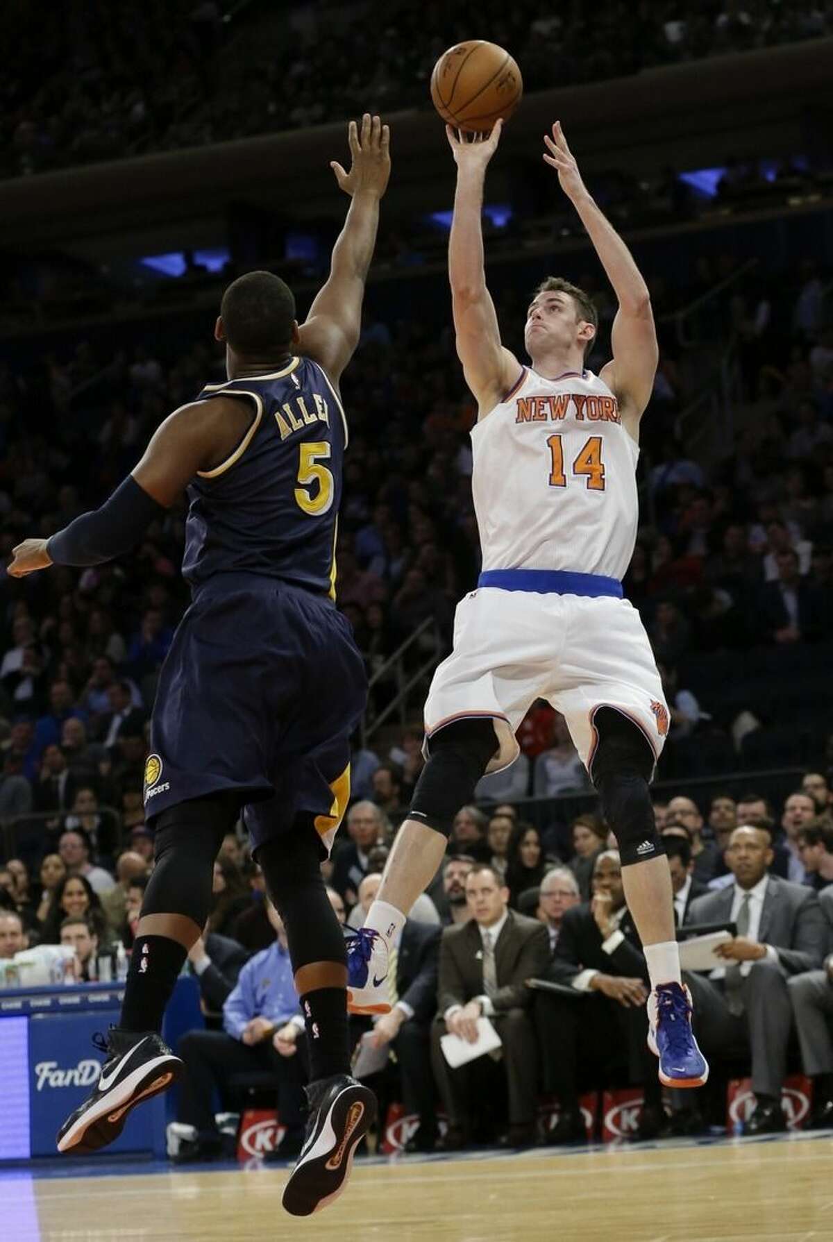 New York Knicks' Jason Smith (14) shoots over Indiana Pacers' Lavoy Allen (5) during the first half of an NBA basketball game Wednesday, April 8, 2015, in New York. (AP Photo/Frank Franklin II)