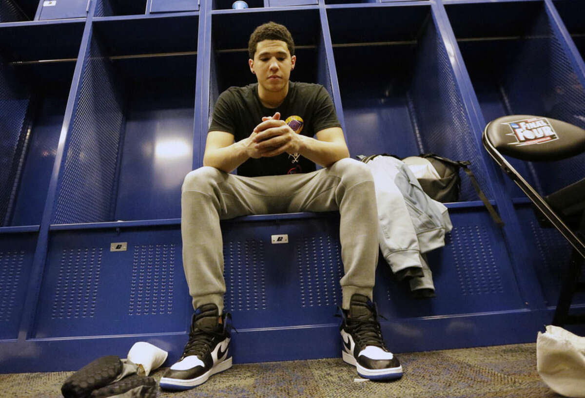 Kentucky's Devin Booker sits in the locker after the NCAA Final Four tournament college basketball semifinal game against Wisconsin Saturday, April 4, 2015, in Indianapolis. Wisconsin won 71-64. (AP Photo/David J. Phillip)