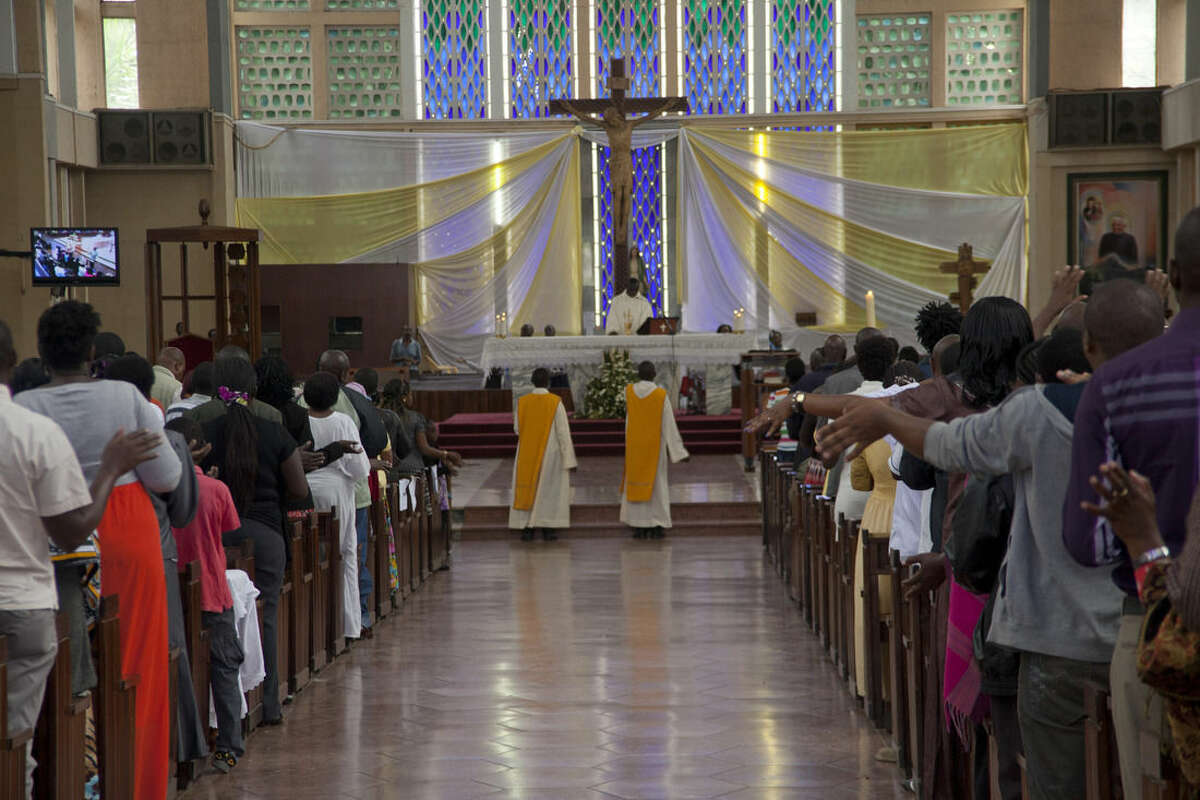 Kenyan Christians pray as they join a morning service at Holy Family Basilica in Nairobi, Kenya, Sunday, April 5, 2015, during Easter Sunday when Christians celebrate the resurrection of their Lord, Jesus Christ, according to Scripture after his crucifixion on the cross. Special prayers were held Sunday for the victims of the recent Garissa University Attack, when Al-Shabab gunmen rampaged through the university in northeastern Kenya on Thursday, killing scores of people. (AP Photo/Sayyid Azim)