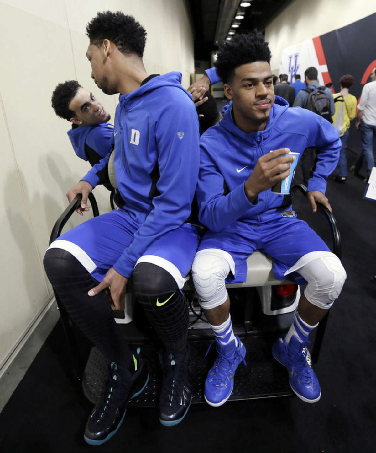 Duke's Tyus Jones, from left, Jahlil Okafor and Quinn Cook get a ride after a news conference for the NCAA Final Four college basketball tournament championship game Sunday, April 5, 2015, in Indianapolis. (AP Photo/Charlie Neibergall)