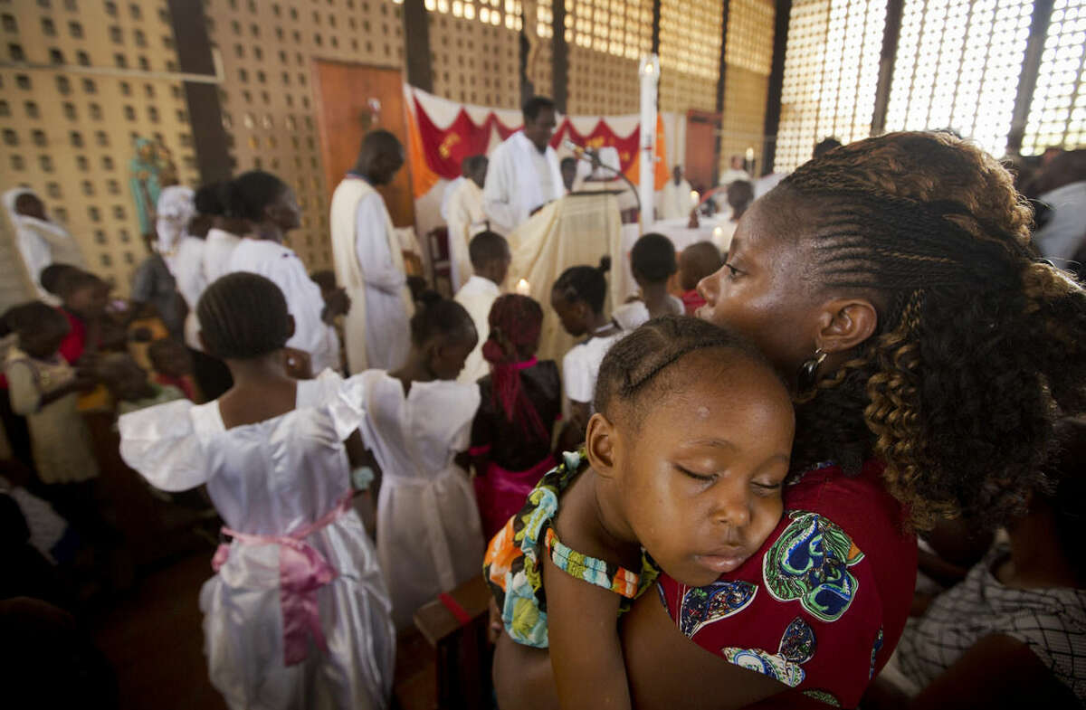 A child sleeps on her mother's shoulder during the service at the Our Lady of Consolation Church, which was attacked with grenades by militants almost three years ago, in Garissa, Kenya, Sunday, April 5, 2015. Easter Sunday's ceremony was laden with emotion for the several hundred members of Garissa's Christian minority, which is fearful following the recent attack on Garissa University College by al-Shabab, a Somalia-based Islamic extremist group, who singled out Christians for killing, though al-Shabab has a long record of killing Muslims over the years. (AP Photo/Ben Curtis)