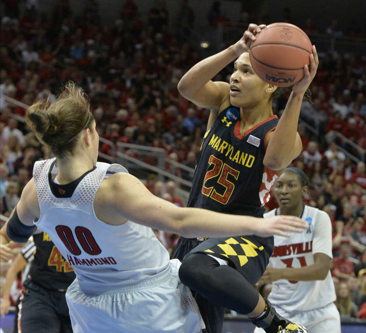 Maryland's Alyssa Thomas, right, charges into Louisville's Sara Hammond during the first half of a regional final in the NCAA women's college basketball tournament, Tuesday, April 1, 2014, in Louisville, Ky. (AP Photo/Timothy D. Easley)