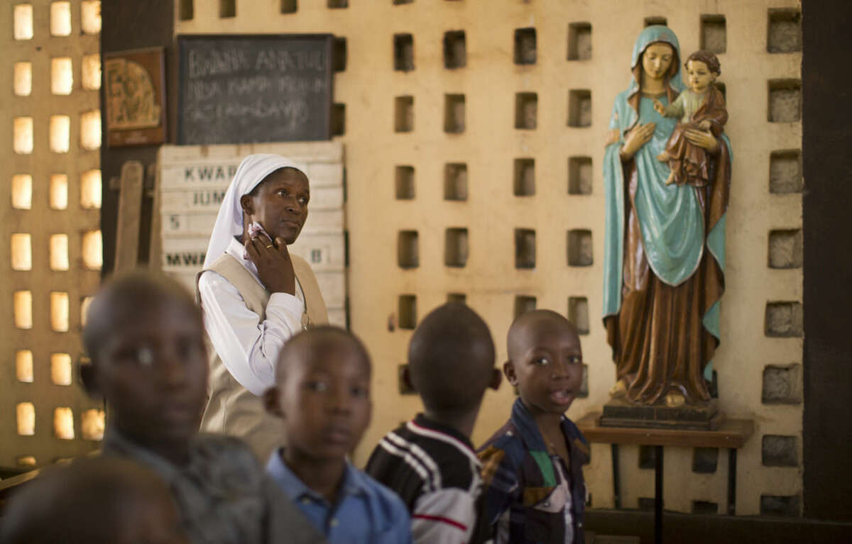 A nun wipes sweat from her neck during the service at the Our Lady of Consolation Church, which was attacked with grenades by militants almost three years ago, in Garissa, Kenya, Sunday, April 5, 2015. Easter Sunday's ceremony was laden with emotion for the several hundred members of Garissa's Christian minority, which is fearful following the recent attack on Garissa University College by al-Shabab, a Somalia-based Islamic extremist group, who singled out Christians for killing, though al-Shabab has a long record of killing Muslims over the years. (AP Photo/Ben Curtis)