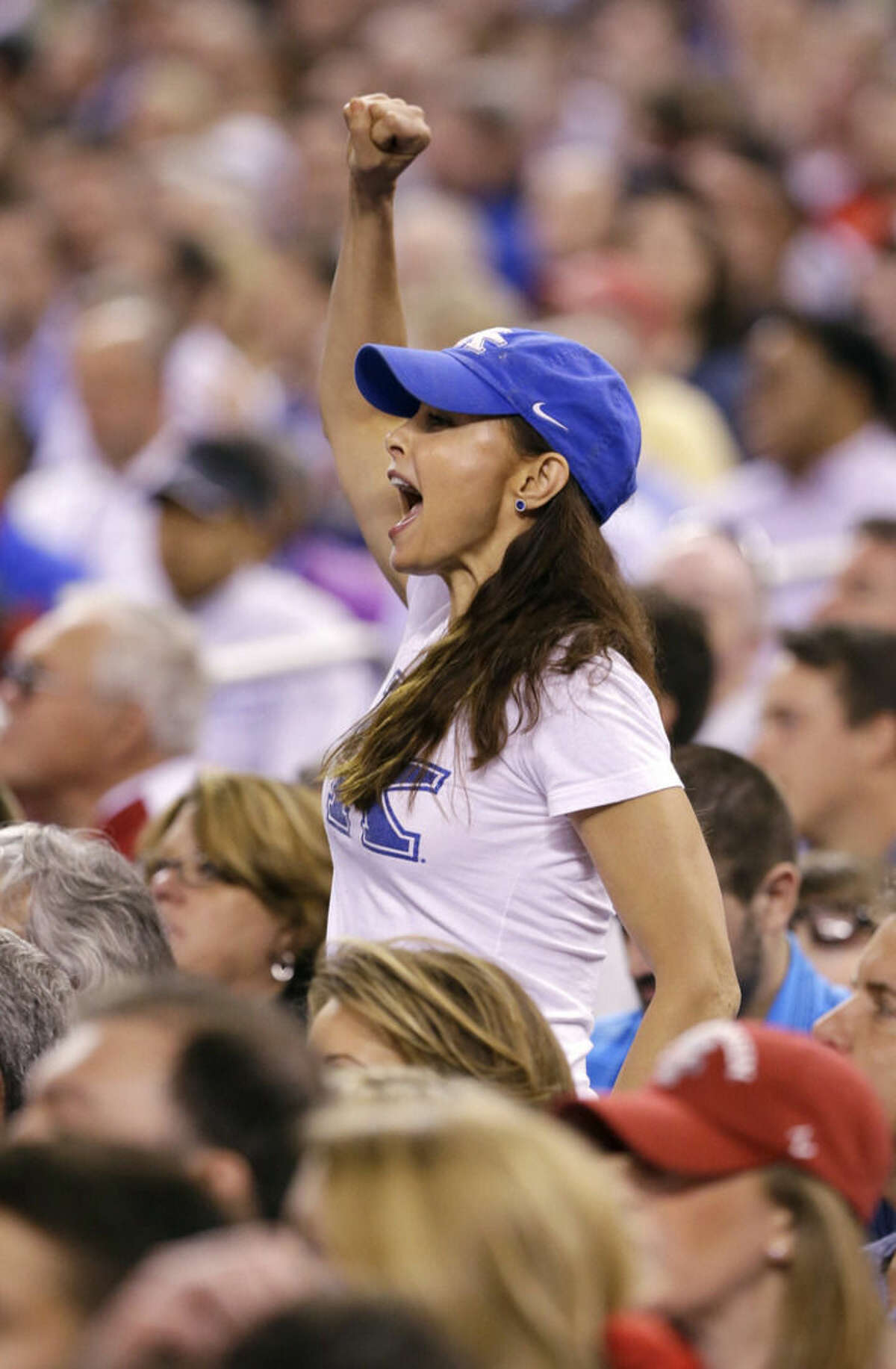 Actor Ashley Judd cheers during the first half of the NCAA Final Four tournament college basketball semifinal game against Wisconsin Saturday, April 4, 2015, in Indianapolis. (AP Photo/Michael Conroy)