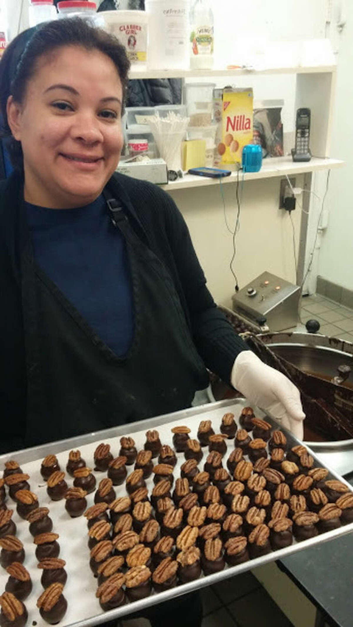 Photo by Frank Whitman Carmina Polanio with finished truffles at Chocolate Rain in Norwalk.
