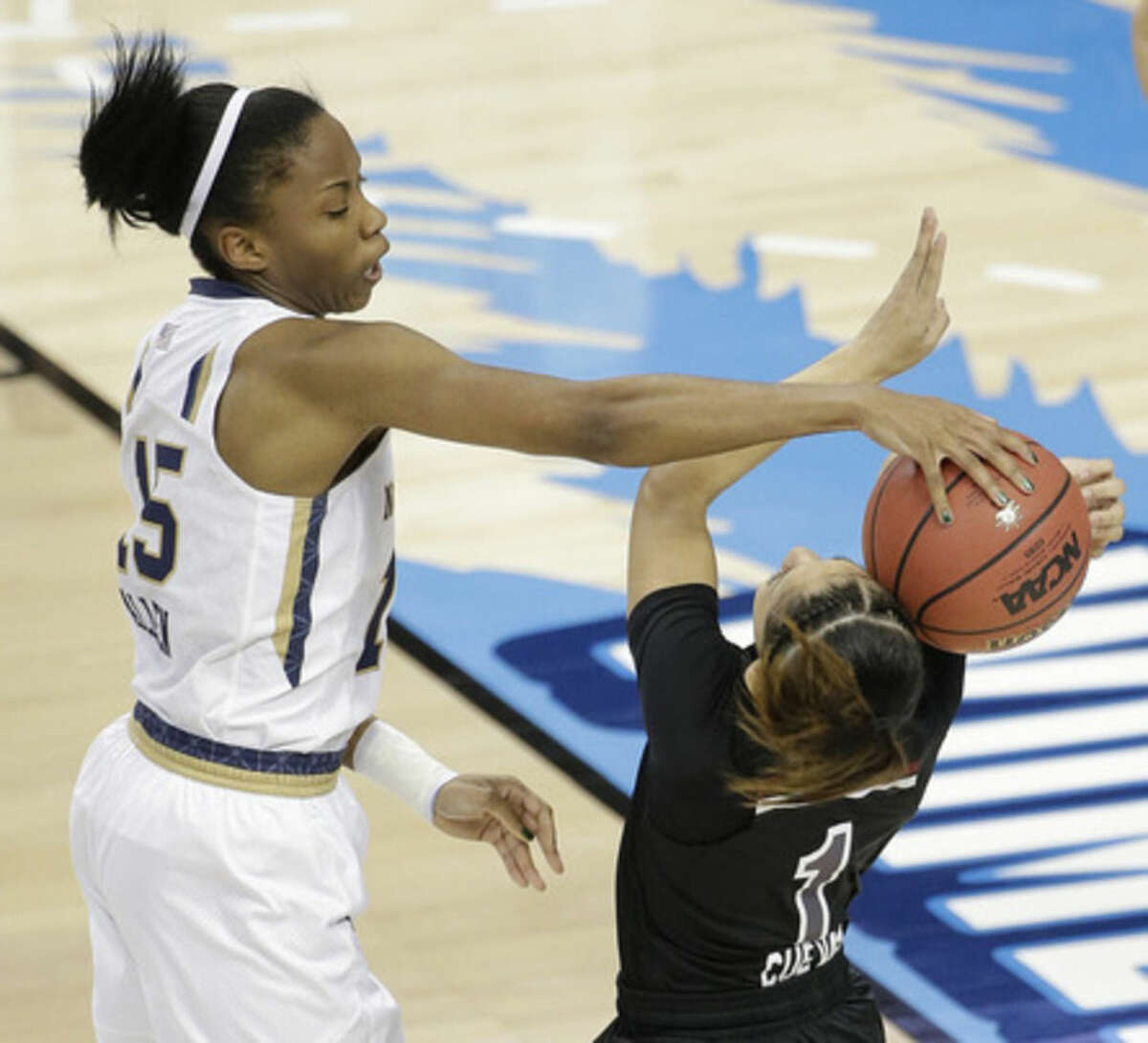 Notre Dame guard Lindsay Allen (15) hits the ball against South Carolina guard Bianca Cuevas (1) during the first half of the NCAA Women's Final Four tournament college basketball semifinal game, Sunday, April 5, 2015, in Tampa, Fla. (AP Photo/Chris O'Meara)