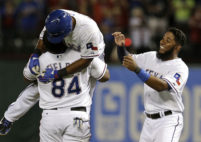 Texas Rangers first baseman Prince Fielder, left, plays with the beard of  shortstop Elvis Andrus as they warm up before facing the Colorado Rockies  in the first inning of a baseball game