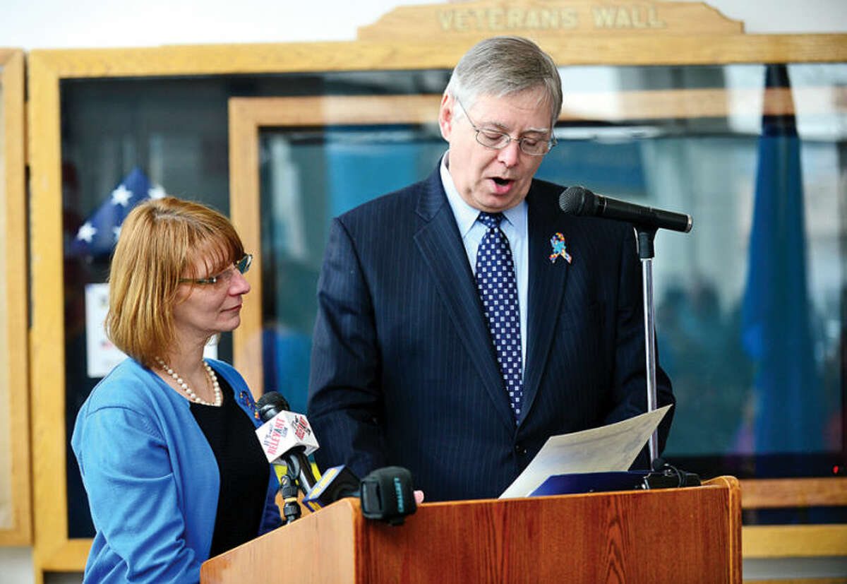 Hour photo / Erik Trautmann Stamford Education 4 Autism (SE4A) president Robin Portanova honors Mayor David Martin as SE4A hosts a World Autism Awareness Day celebration at the Stamford Government Center Wednesday morning. S