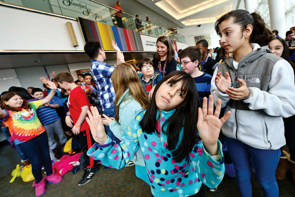 Hour photo / Erik Trautmann Roxbury Elementary School Stamford Education 4 Autism (SE4A) buddy Genna Diaz dances to the opening music as Stamford Education 4 Autism hosts a World Autism Awareness Day celebration at the Stamford Government Center Wednesday morning.