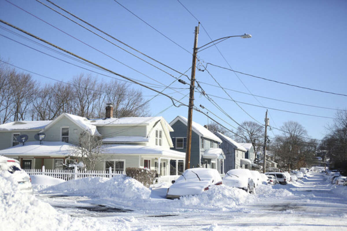 Snow covered cars line Third Street in Norwalk after Winter Storm Jonas Sunday morning. Hour Photo / Danielle Calloway