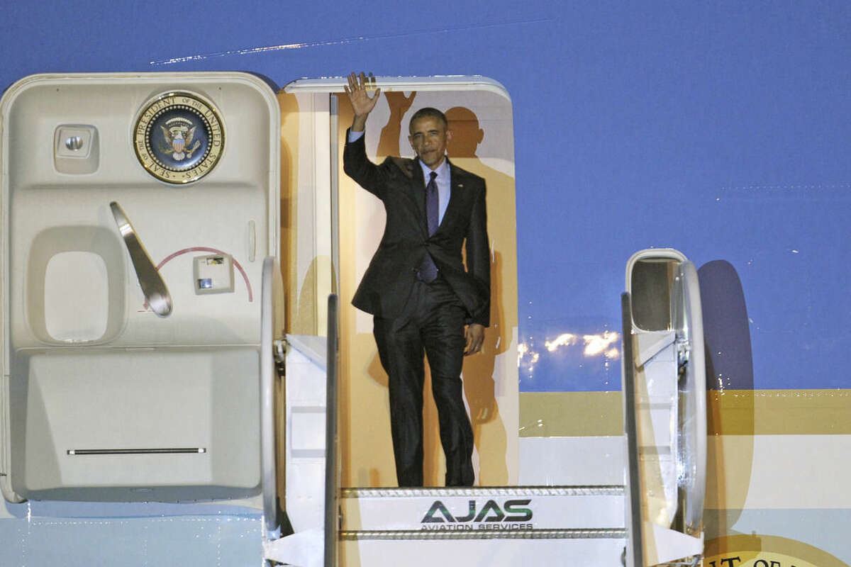 U.S. President Barack Obama waves during his arrival on Air Force One, Wednesday, April 8, 2015 at Norman Manley International Airport in Kingston, Jamaica. Obama arrived to Jamaica for a two day visit and will travel to Panama for the Summit of the Americas, April 10-11. (AP Photo/Ricardo Arduengo)