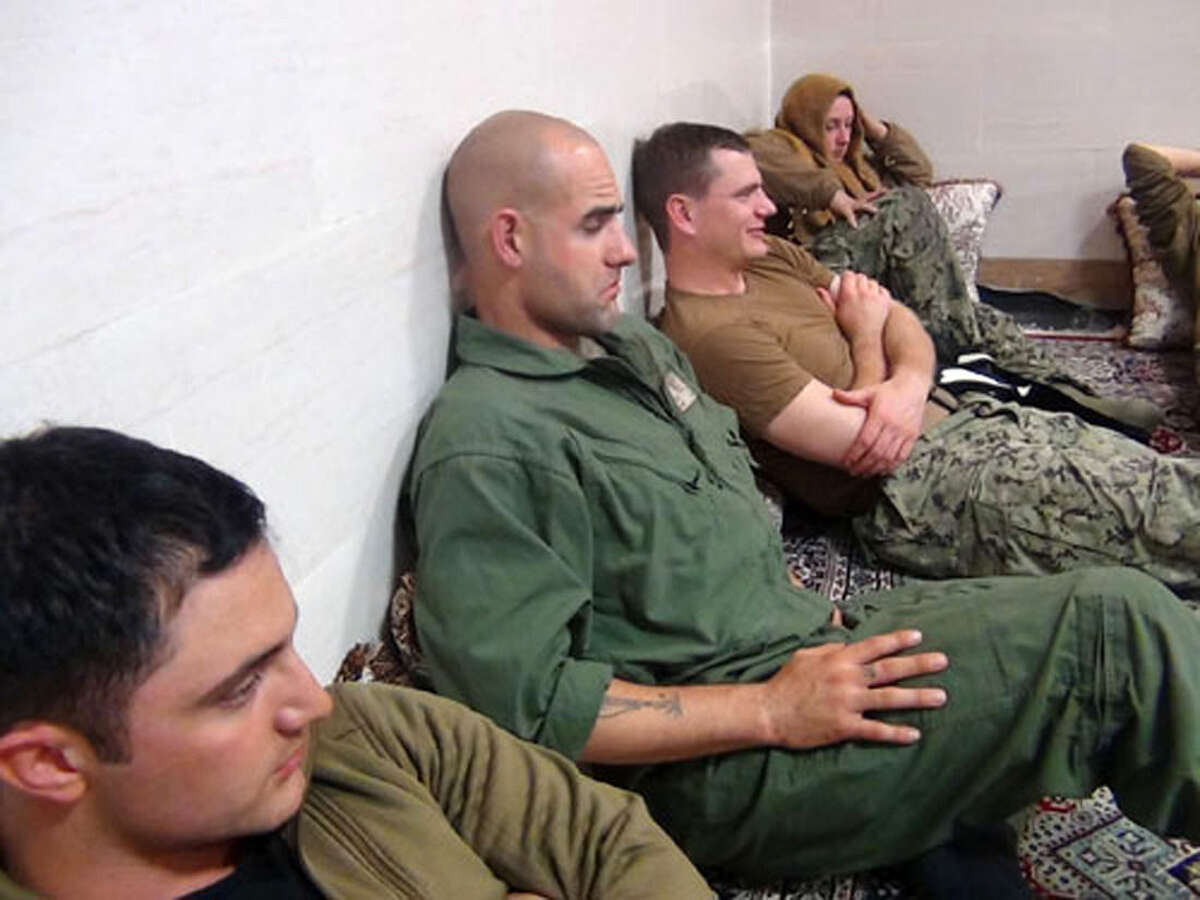 This picture released by the Iranian Revolutionary Guards on Wednesday, Jan. 13, 2016, shows detained American Navy sailors in an undisclosed location in Iran. Iranian state television is reporting that all 10 U.S. sailors detained by Iran after entering its territorial waters have been released. Iran's Revolutionary Guard said the sailors were released Wednesday after it was determined that their entry was not intentional. (Sepahnews via AP)