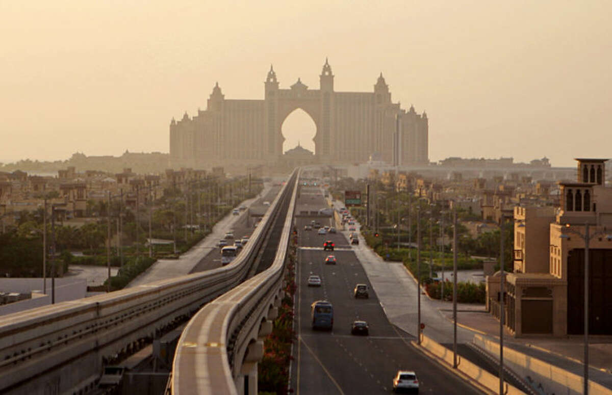 FILE - This Wednesday, Sept. 8, 2010 file photo shows an avenue leading to the Atlantis hotel on the Palm Jumeirah Island in Dubai, United Arab Emirates. A Dubai government conglomerate behind some of the emirate's industrial powerhouses said Thursday, April 3, 2014, it has bought a "significant" stake in the international hotel operator that runs the Atlantis hotel on the city's main palm-shaped island. (AP Photo/Kamran Jebreili, File)