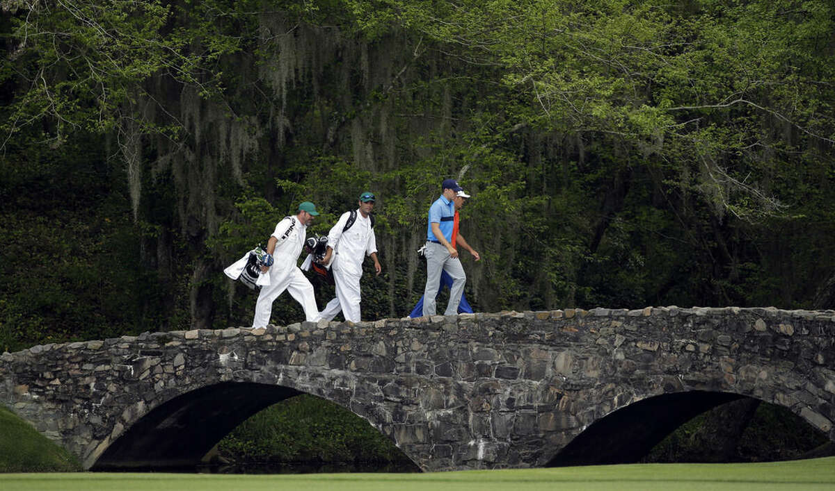 Jordan Spieth, left, walks across the Nelson Bridge with Billy Horschel during the first round of the Masters golf tournament Thursday, April 9, 2015, in Augusta, Ga. (AP Photo/Matt Slocum)