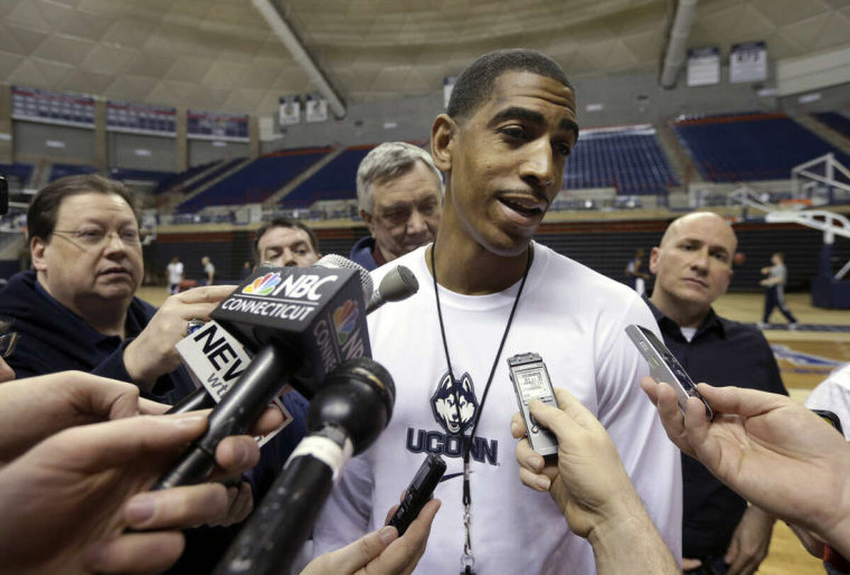 Connecticut's coach Kevin Ollie responds to questions from reporters following an NCAA college basketball team workout Tuesday, April 1, 2014, in Storrs, Conn. UConn will be playing Florida in the Final Four on Saturday in Dallas. (AP Photo/Steven Senne)