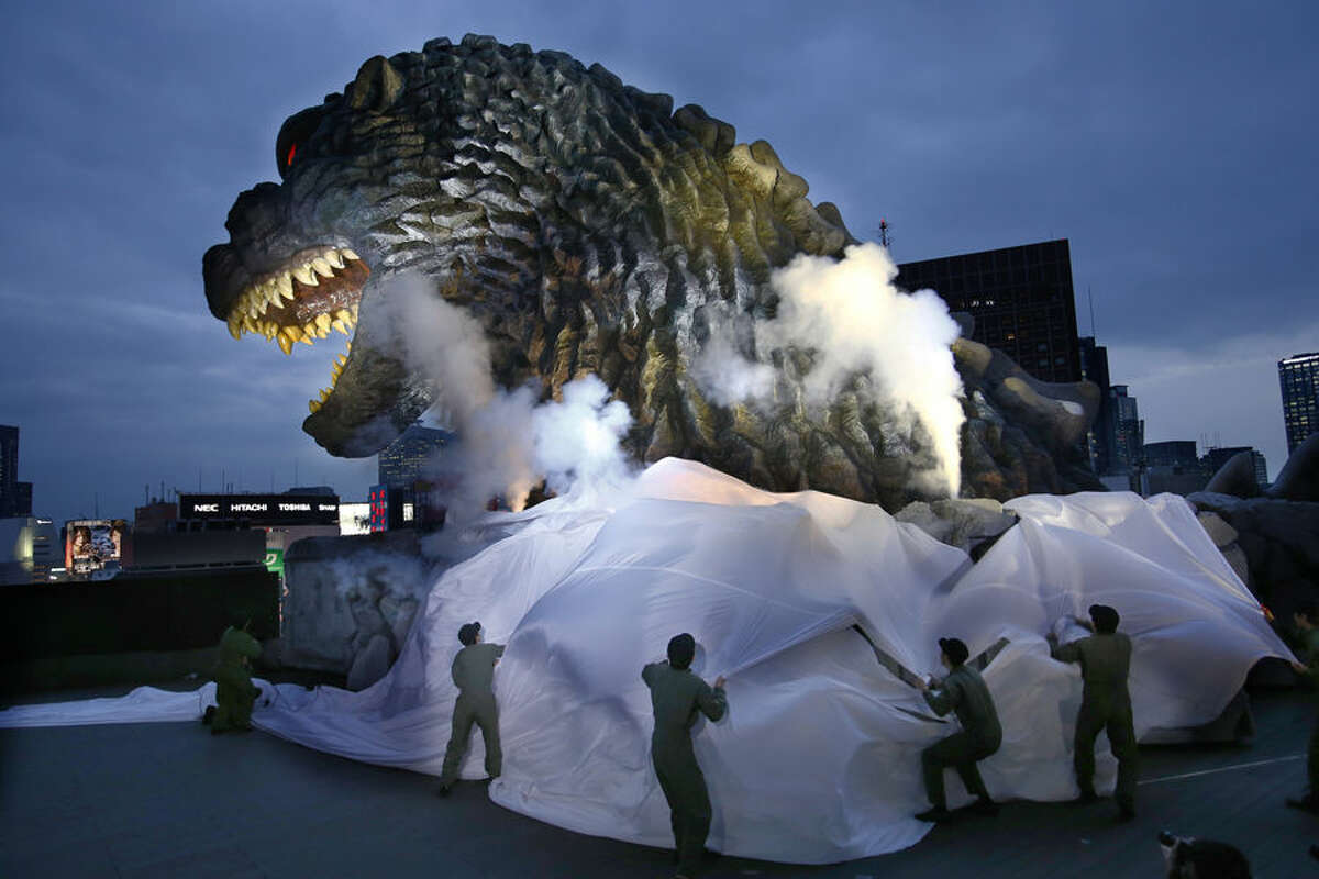 Godzilla's head is unveiled as the irradiated monster was appointed special resident and tourism ambassador for Tokyo's Shinjuku ward during its awards ceremony in Tokyo Thursday, April 9, 2015. The giant Godzilla head towering 52-meters (171 feet) above ground level was unveiled Thursday at an office of Toho, the studio behind the 1954 original. (AP Photo/Shizuo Kambayashi)