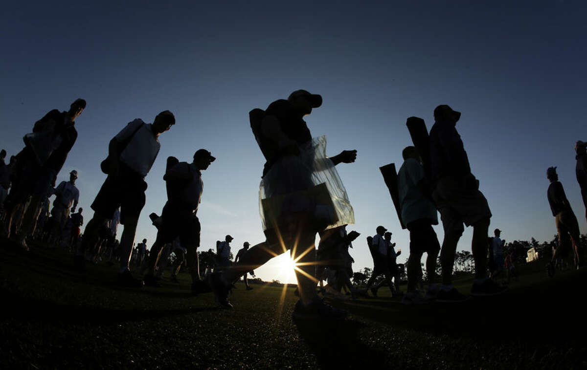 Spectators walk along the first fairway before the first round of the Masters golf tournament Thursday, April 9, 2015, in Augusta, Ga. (AP Photo/Matt Slocum)