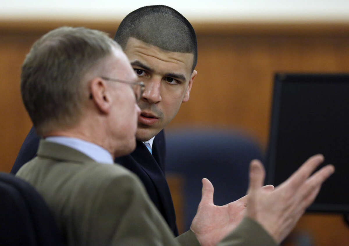 Former New England Patriots football player Aaron Hernandez, right, sits with defense attorney Charles Rankin, left, as the judge and attorneys for both sides discuss questions about evidence from the jury deliberating Hernandez's fate, during his murder trial Thursday, April 9, 2015, in Fall River, Mass. Hernandez is charged with killing Odin Lloyd. (AP Photo/Steven Senne, Pool)