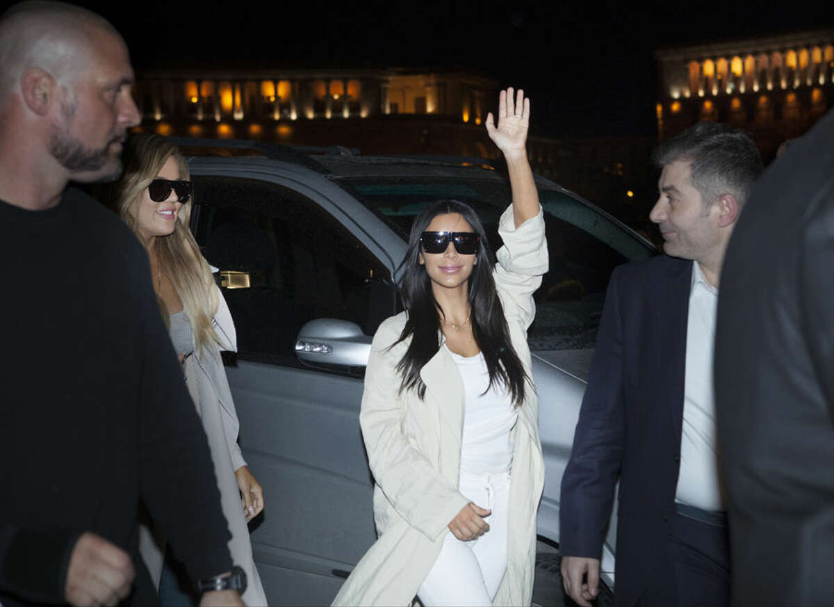 Kim Kardashian waves on her way to a hotel in downtown Yerevan, Armenia, Wednesday, April 8, 2015. American television star Kim Kardashian has arrived in the capital of her ancestral Armenia for a visit expected to draw attention to the centennial of the massacre of 1.5 million Armenians. (AP Photo/Hrant Khachatryan, PAN Photo)