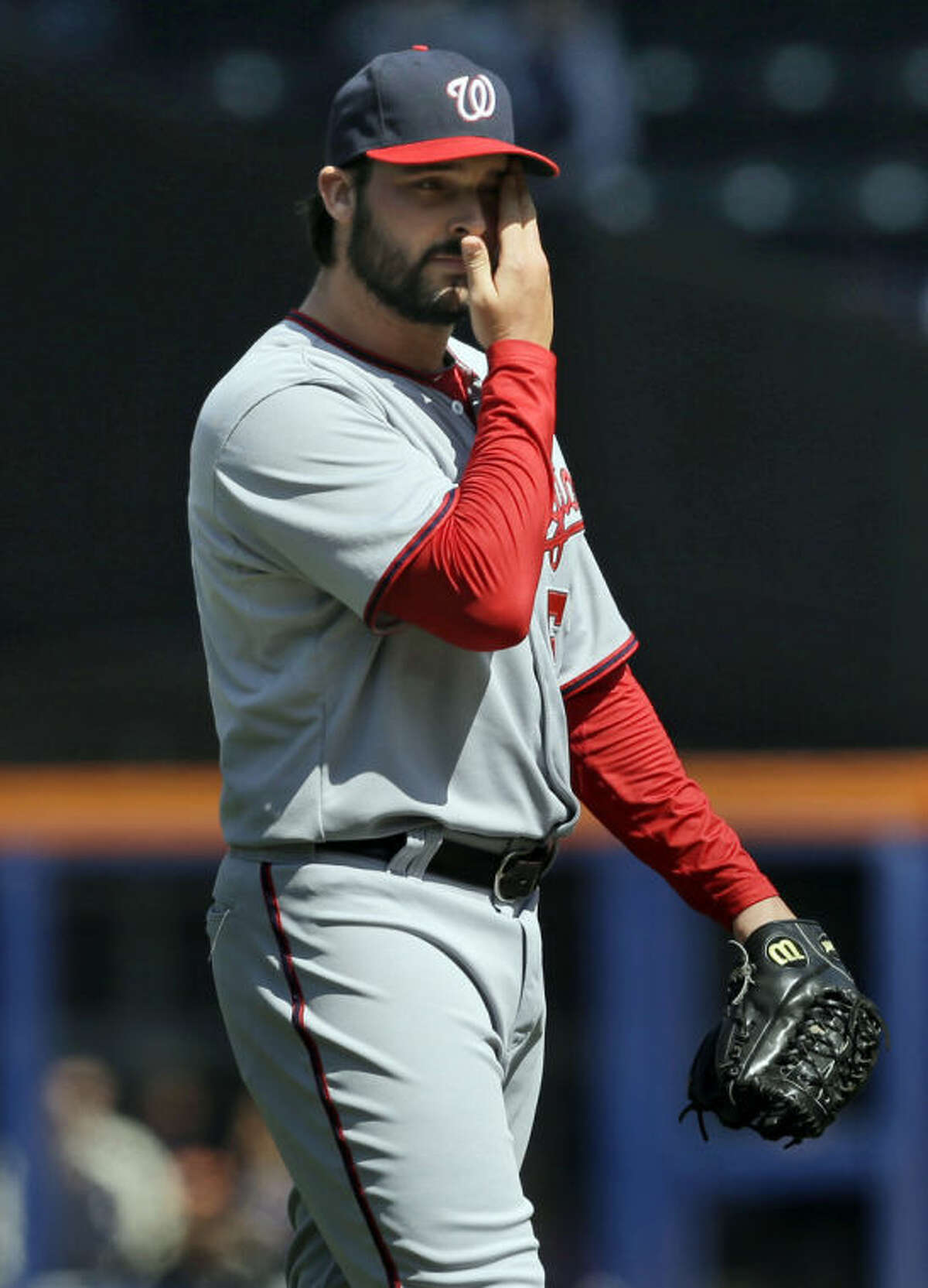 Washington Nationals pitcher Tanner Roark wipes his face during the first inning of the baseball game against the New York Mets at Citi Field, Thursday, April 3, 2014, in New York. (AP Photo/Seth Wenig)