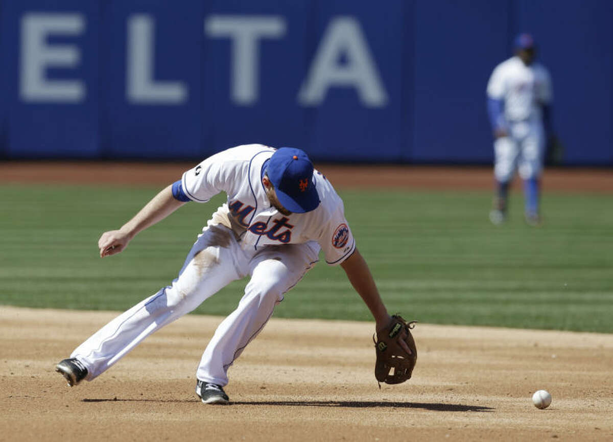 New York Mets second baseman Daniel Murphy commits a fielding error on a ball hit by Washington Nationals' Denard Span during the fourth inning of the baseball game at Citi Field, Thursday, April 3, 2014 in New York. (AP Photo/Seth Wenig)
