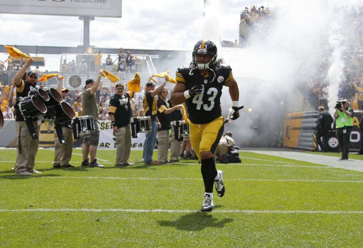 FILE - In this Sept. 7, 2014, file photo, Pittsburgh Steelers strong safety Troy Polamalu (43) takes the field during introductions for an NFL football game against the Cleveland Browns in Pittsburgh. Polamalu's iconic football career is over. The eight-time Pro Bowl safety told the Uniontown Herald-Standard he informed Steelers chairman Dan Rooney on Thursday night, April 9, 2015, he will retire rather than return for a 13th season. (AP Photo/Gene Puskar, File)
