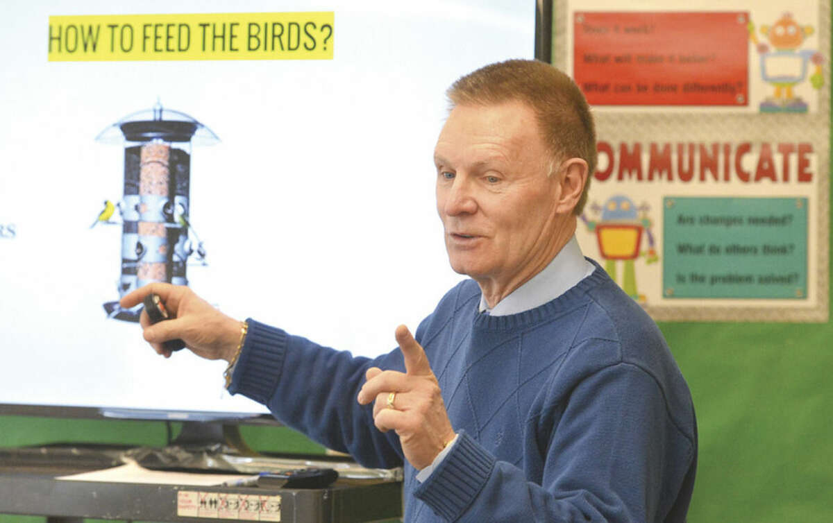 Hour Photo/Alex von Kleydorff All Saints School Teacher John Cook gives kids in his STEM program instructions on the workings of a bird feeeder, they are challenged to design and build a bird feeder using re pourposed objects such as water bottles