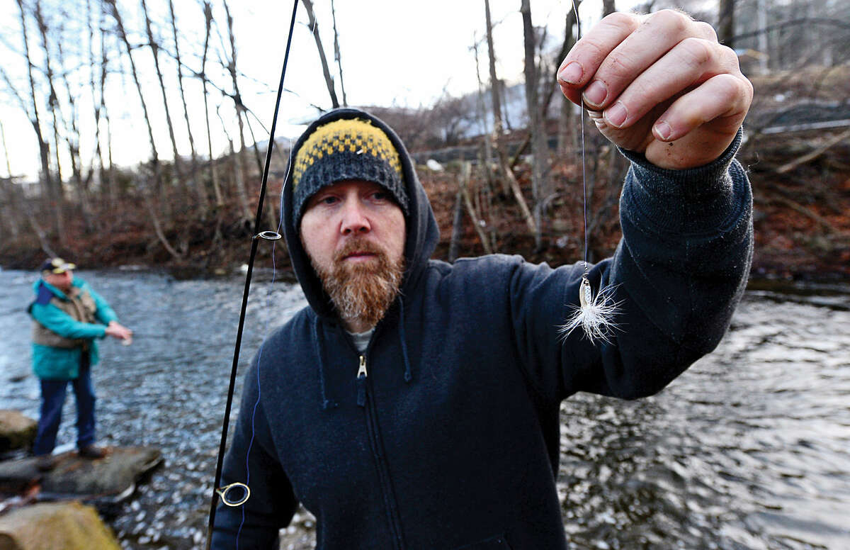 Hour photo / Erik Trautmann Local resident including Steve Snellman fish for trout on the Norwalk River in Wilton on Opening Day Saturday.