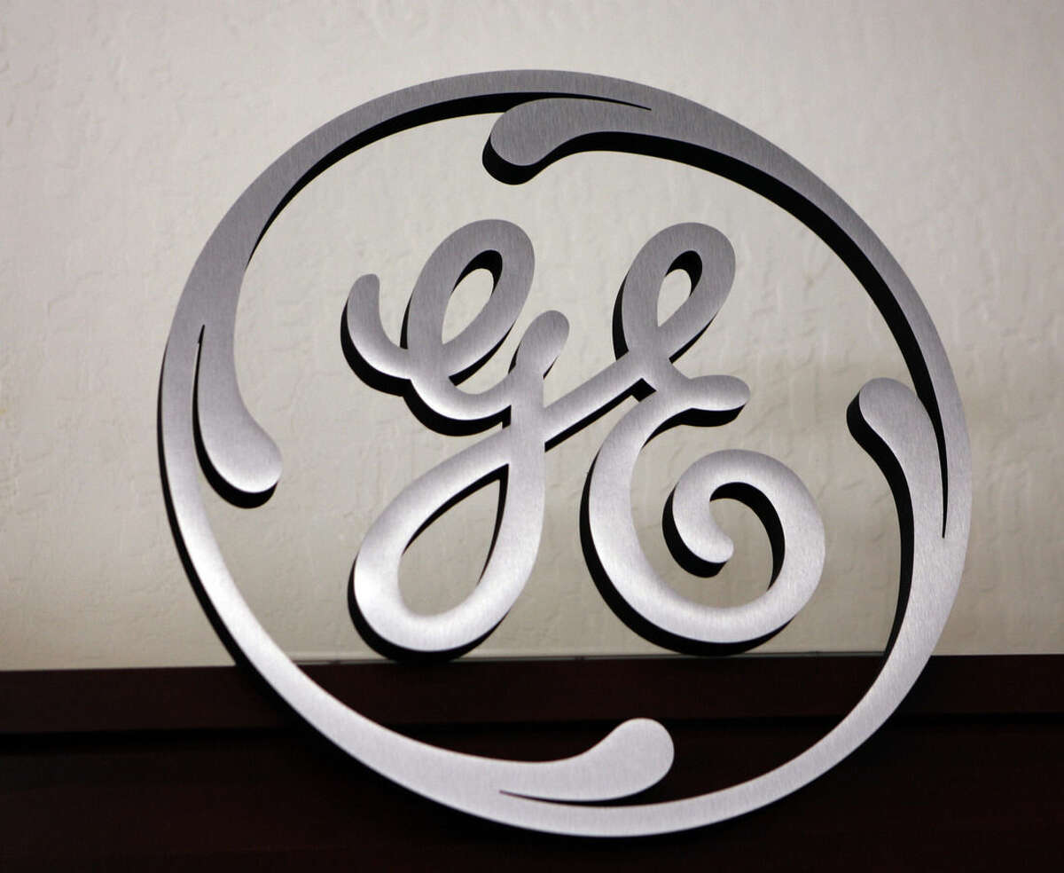 FILE - In this file photo taken Dec. 2, 2008, a General Electric (GE) sign is seen on display at Western Appliance store in Mountain View, Calif. General Electric will sell most of GE Capital as it turns its focus more to its industrial business and away from a big money generator that also made some investors nervous. The company will buy back as much as $50 billion of its own stock, sending shares up 6 percent before the opening bell Friday April 10, 2015 and toward a new high for the year. (AP Photo/Paul Sakuma, File)