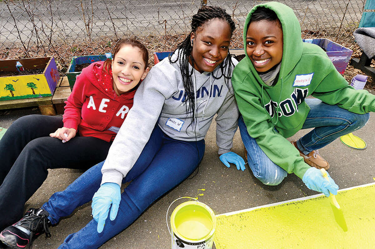 Hour photo / Erik Trautmann UCONN students Carolina Angel, Danielle Wilkinson and Shakyla Evans, volunteer with the Stamford Public Education Foundation (SPEF) park clean-up and rebuild at Cedar Street Park in Stamford’s South End Saturday.