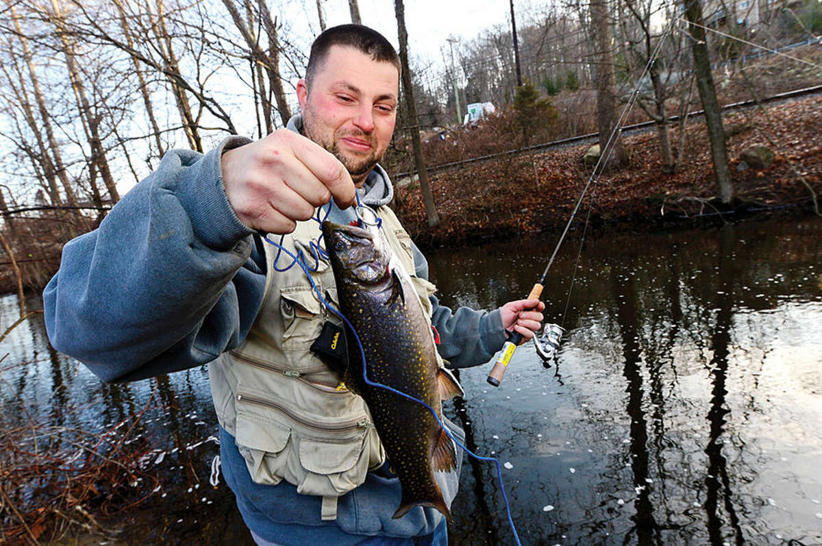 Hour photo / Erik Trautmann Local resident including Kevin Botelho fish for trout on the Norwalk River in Wilton on Opening Day Saturday.