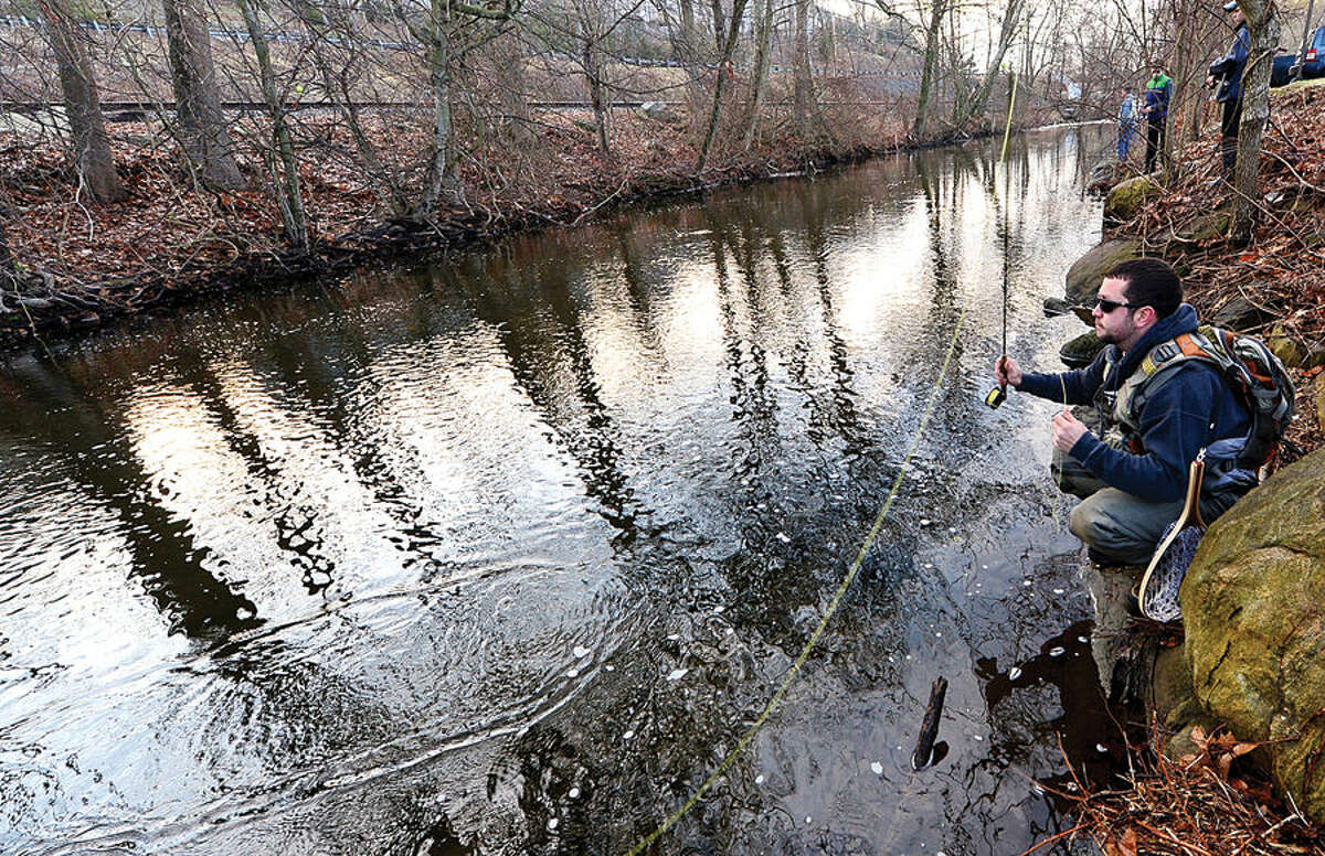 Hour photo / Erik Trautmann Local resident including Tom Lametta fish for trout on the Norwalk River in Wilton on Opening Day Saturday.