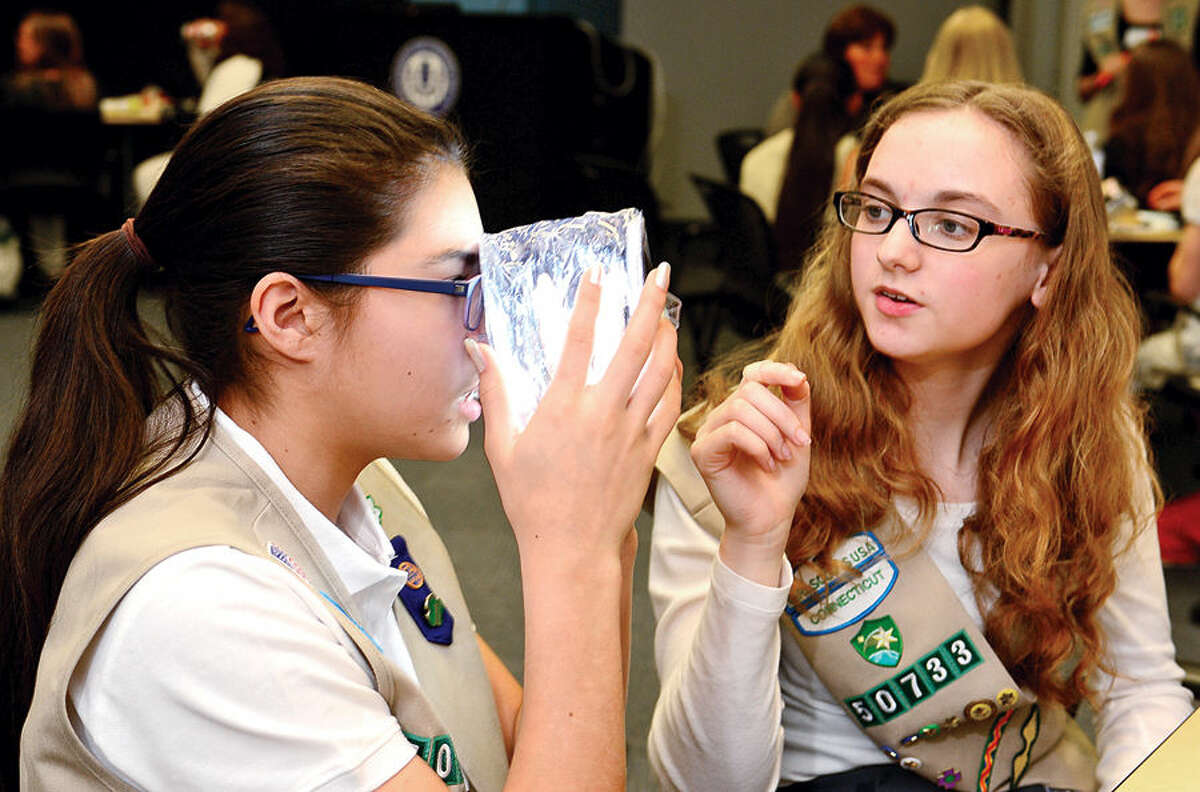 Hour photo / Erik Trautmann Girl Scouts Katie Matuoka and Jillian Stark work on their project as The International Womens Forum of Connecticut hosts a group of Girl Scouts at the UCONN School of Business in Stamford for an interactive workshop focused on STEM (Science Technology Engineering and Math) featuring the solar powered Luci Light. The girlscouts worked with leading executive women from across the state to form product development and marketing strategies for an enhanced Luci Light.