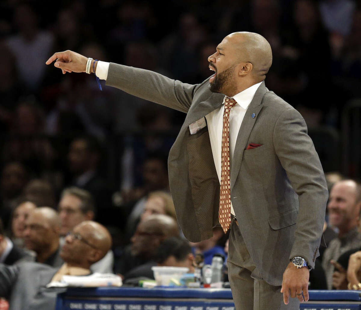New York Knicks head coach Derek Fisher talks to his players during the second half of the NBA basketball game against the Denver Nuggets, Sunday, Feb. 7, 2016, in New York. The Nuggets defeated the Knicks 101-96. (AP Photo/Seth Wenig)