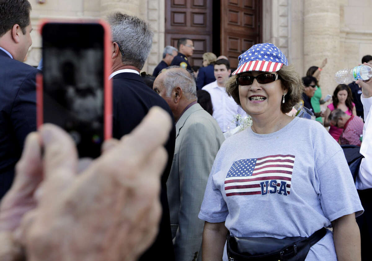 Barbara Rodriguez, of Miami, poses for a photograph outside of the Freedom Tower where Sen. Marco Rubio, R-Fla., is launching his Republican presidential campaign, Monday, April 13, 2015, in Miami. Rodriguez arrived in the U.S. from Cuba 49 years ago, and had her immigration papers processed in the Freedom Tower. (AP Photo/Lynne Sladky)