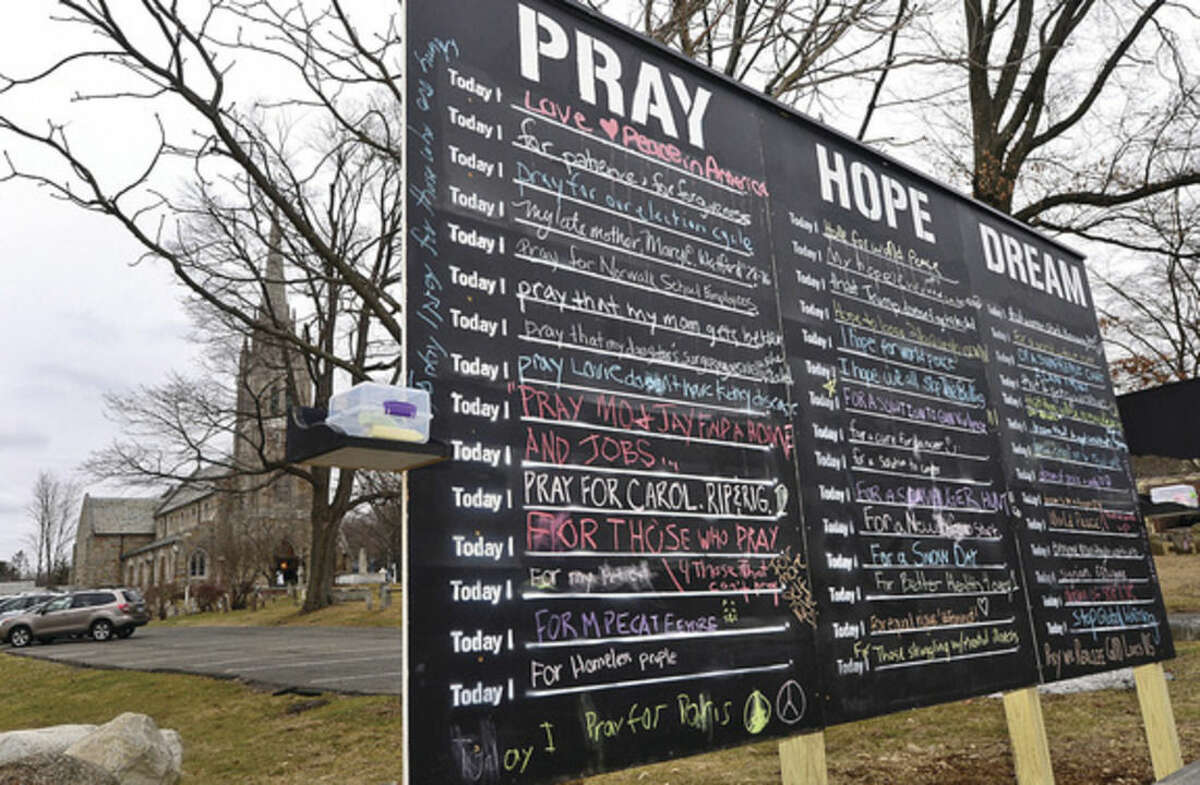 Hour photo / Erik Trautmann St. Paul's on the Green erected a prayer sign where passers-by are encouraged to write a prayer, hope or dream with chalk on the sign.